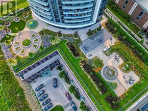 Toronto (Islington-City Centre West) condo for rent - A modern building with a circular garden in front.