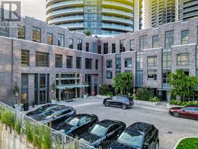 Toronto (Islington-City Centre West) condo for rent - A parking lot with cars and a building with the sign "REALTOR" in the background.