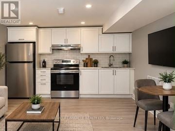 Brampton (Fletcher's West) apartment for rent - A modern kitchen with white cabinets and stainless steel appliances.