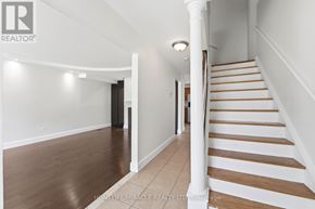 Hamilton (Gourley) apartment for rent - A living room with a fireplace and a refrigerator in the background.