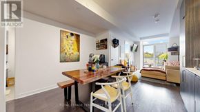 Toronto (Waterfront Communities) condo for rent - A dining room with a wooden table and chairs.