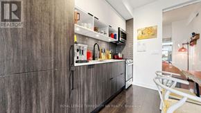 Toronto (Waterfront Communities) condo for rent - A kitchen with a wooden cabinet and a white counter.