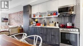 Toronto (Waterfront Communities) condo for rent - A modern kitchen with a dining table and chairs.