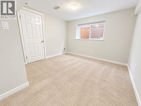 Burnaby apartment for rent - A bedroom with a carpeted floor and a window with blinds.