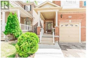 Brampton (Madoc) apartment for rent - A house with a brown brick exterior and a white garage door.