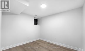 Brampton (Madoc) apartment for rent - A white room with a wooden floor and a window.
