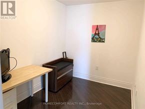 Toronto (Willowdale East) condo for rent - A room with a television, a table, a couch and a painting of the Eiffel Tower on the wall.