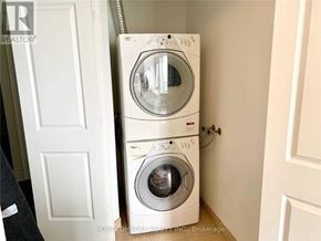 Toronto (Willowdale East) condo for rent - A white washing machine and dryer stacked on top of each other in a small room.