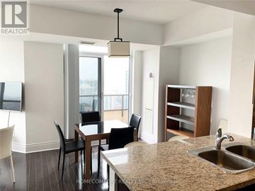 Toronto (Willowdale East) condo for rent - A kitchen with a table and chairs in front of a window.