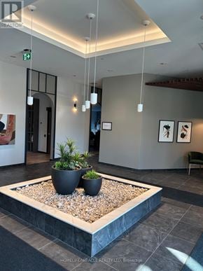 Kitchener condo for rent - A reception area with a planter in the middle.
