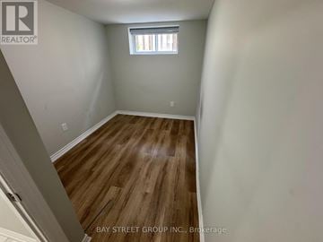 Toronto (Eglinton East) apartment for rent - A room with wooden flooring and a window.