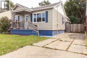 St. Catharines (Facer) apartment for rent - A house with a blue front door and a porch.