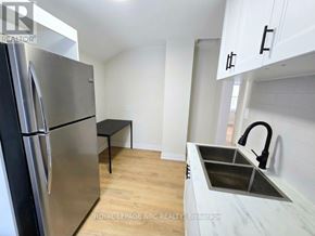 Port Colborne (East Village) fourplex for rent - A kitchen with a stainless steel refrigerator and a marble countertop.