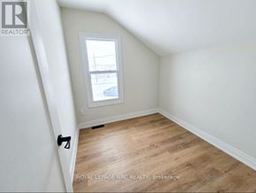 Port Colborne (East Village) fourplex for rent - A room with a window and wooden flooring.