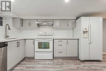 Toronto (Trinity-Bellwoods) apartment for rent - A white kitchen with a refrigerator, oven, and cabinets.