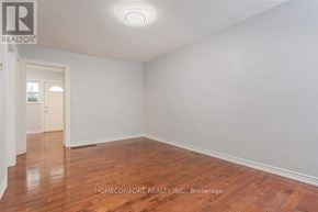 Toronto (Trinity-Bellwoods) apartment for rent - A room with wooden flooring and white walls, with a doorway leading to another room.