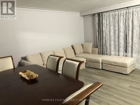 Toronto (Woburn) apartment for rent - A dining room with a round table and a couch.