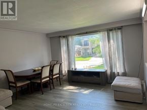 Toronto (Woburn) apartment for rent - A room with a table and chairs in front of a window with curtains.