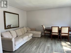 Toronto (Woburn) apartment for rent - A living room with a couch, chair, and table.