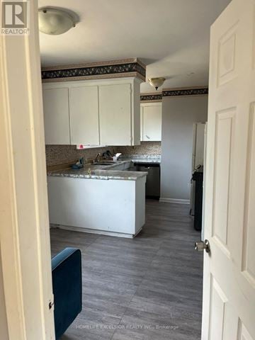 Toronto (Woburn) apartment for rent - A kitchen with white cabinets and a countertop.
