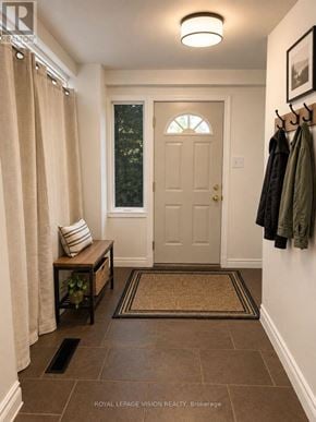 Oshawa (O'neill) apartment for rent - A hallway with a bench, coat rack, and a door.