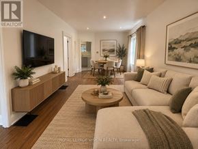 Oshawa (O'neill) apartment for rent - A living room with a television, a coffee table, and a couch.