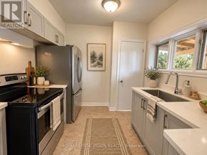 Oshawa (O'neill) apartment for rent - A kitchen with a refrigerator, oven, and sink.