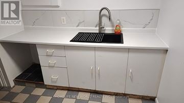 Mississauga (Central Erin Mills) apartment for rent - A white sink with a black drain in a white kitchen.