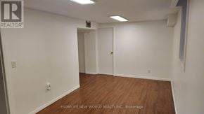 Mississauga (Central Erin Mills) apartment for rent - A room with white walls and wooden flooring, with a door on the right side.