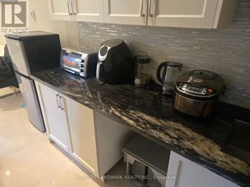 Toronto (Lawrence Park North) apartment for rent - A black and silver toaster and coffee maker sit on a kitchen counter.