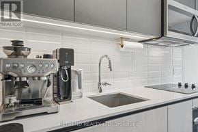Toronto (South Riverdale) condo for rent - A modern kitchen with a coffee machine and a sink.