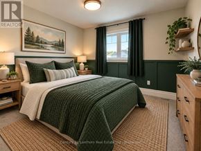 Prince Edward County (Picton Ward) townhouse for rent - A bedroom with a bed, nightstands, and a painting on the wall.
