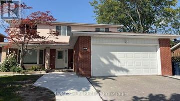 Toronto (Agincourt North) apartment for rent - A house with a white garage door and a red brick wall.