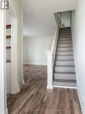 St. Catharines (E. Chester) apartment for rent - A staircase with wooden steps and white railings.