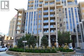 Mississauga (City Centre) condo for rent - A large building with a sign that says "REALTOR" in the foreground.