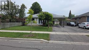 Toronto (Mount Olive-Silverstone-Jamestown) apartment for rent - A residential street with a white house and parked cars.