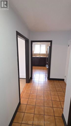 Toronto (Mount Olive-Silverstone-Jamestown) apartment for rent - A room with a tiled floor and a doorway leading to another room.