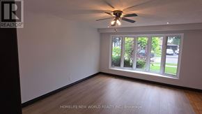 Toronto (Mount Olive-Silverstone-Jamestown) apartment for rent - A room with a ceiling fan and a window overlooking a green area.