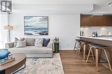 Toronto (Waterfront Communities) condo for rent - A living room with a couch, a coffee table, and a painting on the wall.