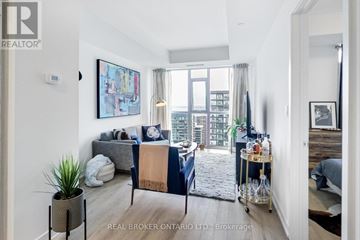 Toronto (Niagara) condo for rent - A living room with a grey couch and a blue and beige sofa.