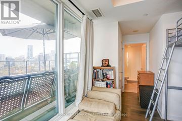 Toronto (Kensington-Chinatown) condo for rent - A living room with a sofa and a bookshelf.