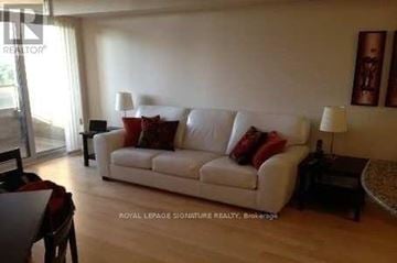 Toronto (Willowdale East) condo for rent - A living room with a white couch and a coffee table.