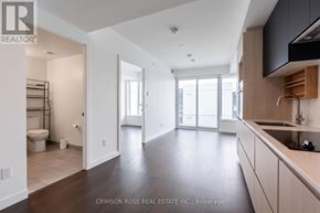 Toronto (Church-Yonge Corridor) condo for rent - A spacious kitchen and living room with dark wood floors and white walls.