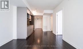 Toronto (Church-Yonge Corridor) condo for rent - A long hallway with white walls and wood floors.