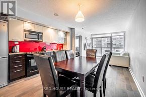 Toronto (Waterfront Communities) condo for rent - A modern kitchen with a dining table and chairs.