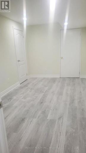 Brampton (Northwest Sandalwood Parkway) apartment for rent - A room with wood flooring and white walls.
