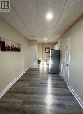 Mississauga (Lakeview) apartment for rent - A long hallway with a refrigerator in the middle.
