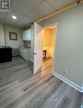 Mississauga (Lakeview) apartment for rent - A room with a wooden floor and a white door.