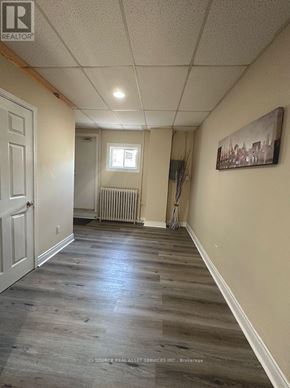 Mississauga (Lakeview) apartment for rent - A room with a white door and a window with a radiator underneath it.