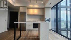 Hamilton (Beasley) condo for rent - A modern kitchen with a dining table and chairs.